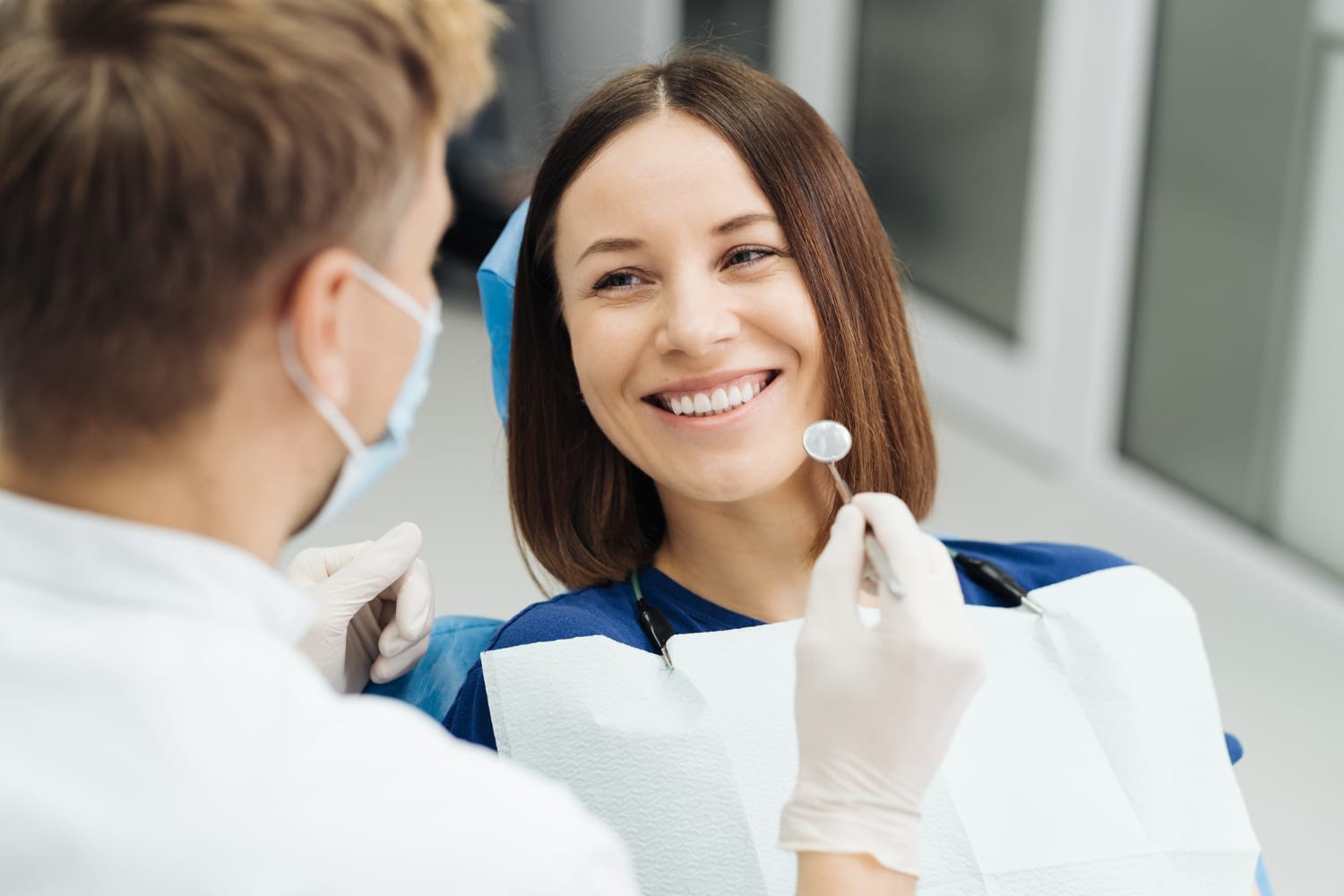 https://www.traviswilsondmd.com/wp-content/uploads/2022/11/male-professional-dentist-with-gloves-mask-discuss-what-treatment-will-look-like-patient-s-teeth.jpg